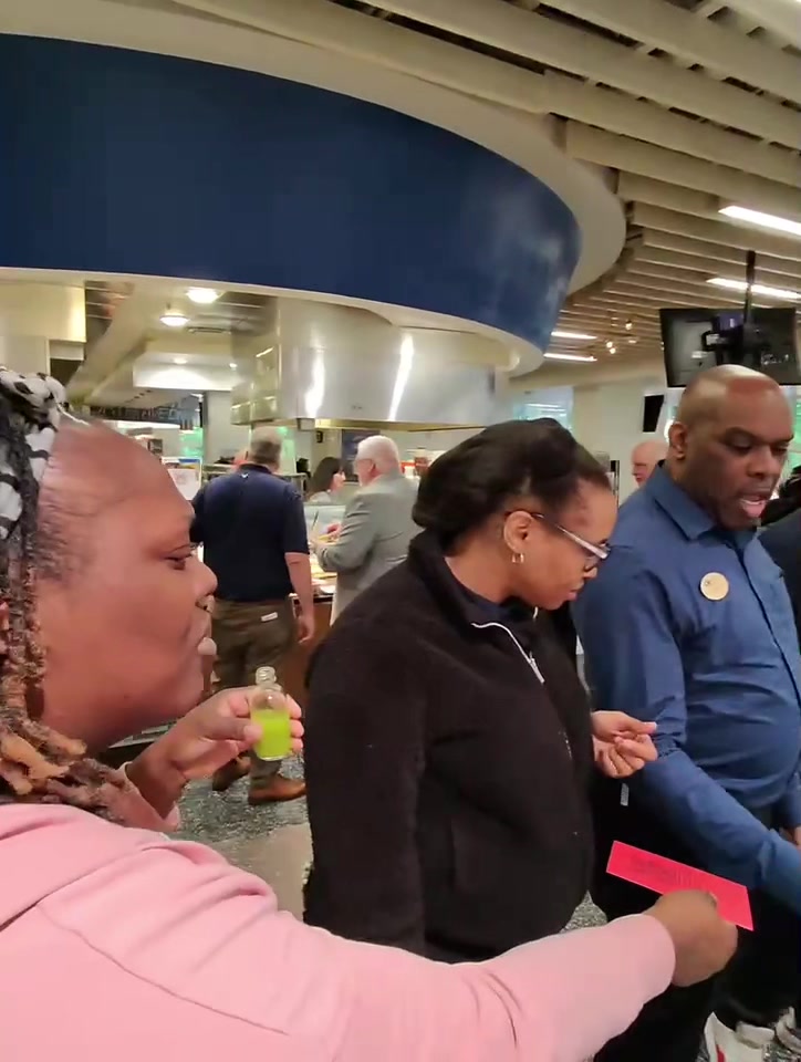 Guests tasting Juice Lady wellness shots at an event